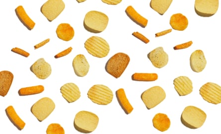 An assortment of different crisps and snacks shot against a white background