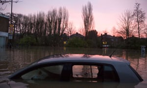 A car is left submerged after the River Foss burst its banks in Yorkshire.