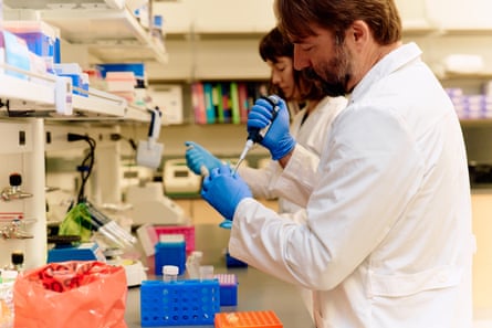 people in white coats in a lab