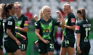 Pernille Harder celebrates with teammates after opening the scoring from the penalty spot.
