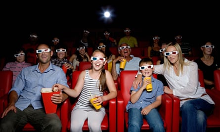 Family wearing 3D glasses at the movies.