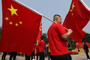 A visitor carries the national flag at Xibaipo Memorial Hall