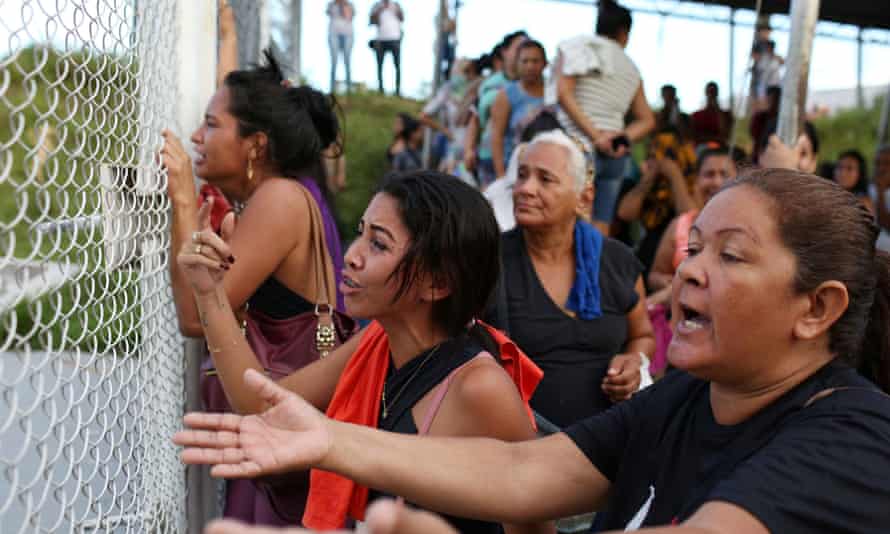Relatives of inmates wait for news outside a prison in the state of Amazonas.