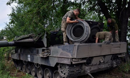Ukrainian soldiers repair a Leopard 2 tank in Zaporizhzhya region, Ukraine, on June 21, 2023.