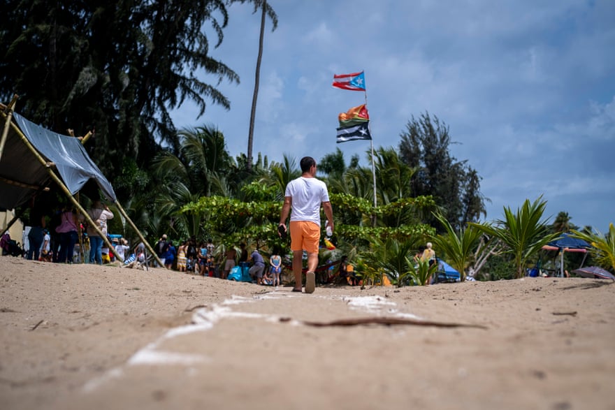 Eliezer Molina walks over the remains of an illegally built wall during a protest in Los Almendros beach.