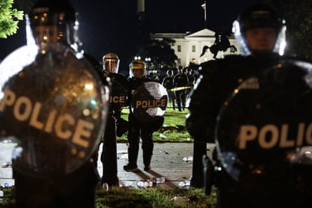 Members of the US Secret Service hold a perimeter near the White House as demonstrators gather to protest the killing of George Floyd on Saturday in Washington DC.