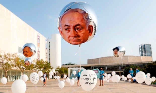 Balloons bearing the face of Benjamin Netanyahu in an installation in Tel Aviv that symbolises broken promises made by the Israeli prime minister.