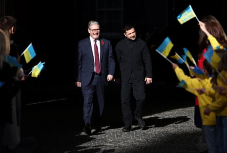 British prime minister Keir Starmer and Ukrainian President Zelenskiy are greeted by Ukrainian schoolchildren as they arrive at the Foreign, Commonwealth and Development Office (FCDO), for a meeting of the Coalition of the Willing, in London, Britain, 24 October 2025.