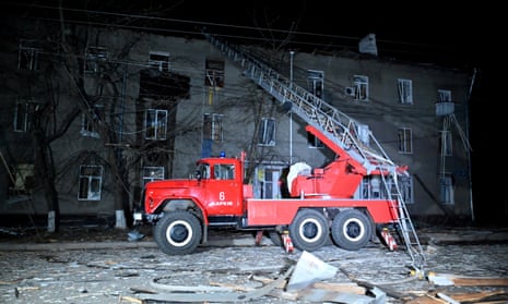 An emergency vehicle is seen among debris next to a residential building following a missile attack in Kharkiv on April 4.