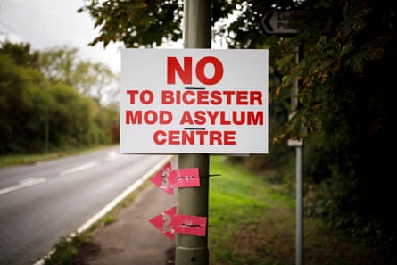 A sign on a roadside pole, reading ‘NO to Bicester MOD asylum centre’