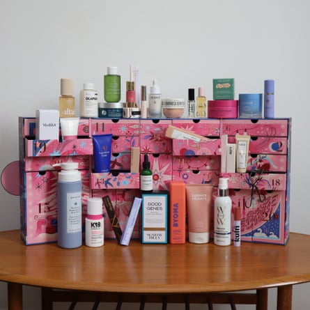 SpaceNK beauty Advent calendar open on a table, with its beauty products arranged alongside it