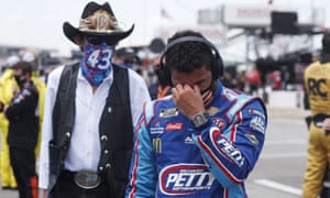 Bubba Wallace, right, is overcome with emotion as he and team owner Richard Petty walk to his car in the pits of the Talladega Superspeedway on Monday