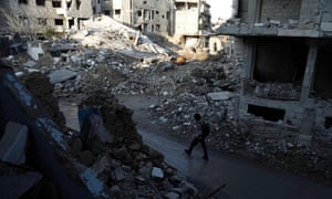 A street damaged by shelling on the outskirts of Damascus