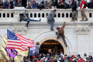 A mob of supporters of US President Donald Trump fight with members of law enforcement at a door they broke open as they storm the U.S. Capitol Building in Washington, 6 January 2021.Leah Millis was covering the rally when she heard about the assault on the Capitol and headed there as it fell under siege. She captured images of crowds fighting police and swarming up scaffolding that had been erected for Biden’s inauguration on 20 January.