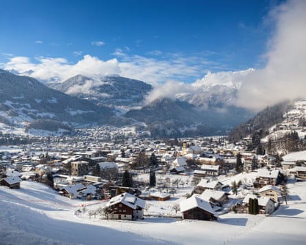 snowy town encircled by peaks
