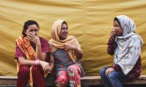 Nor-Ain Ibrahem, 25, (centre) sits with her friends Ashlia Mandangan, 17, (left) and Aenesah Capal, 19 (right) in Landar evacuation centre. All three have been attending the WFS for three months.