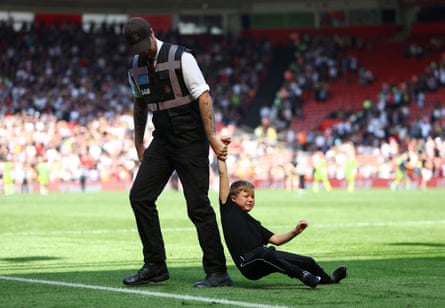 A young pitch invader is removed from the pitch, Southhampton, UK