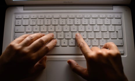 fingers typing on a keyboard