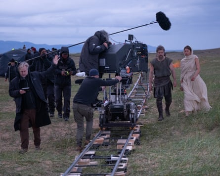 Christopher Nolan, left, on set with Matt Damon and Zendaya, right.
