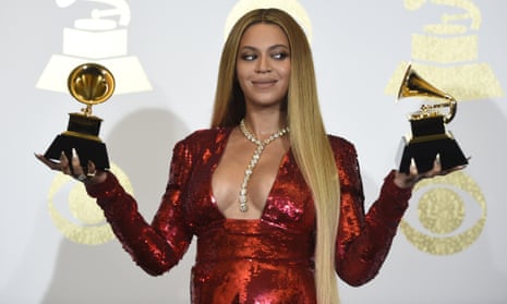 Beyoncé poses with the awards for best music video and best urban contemporary album at the Grammys.