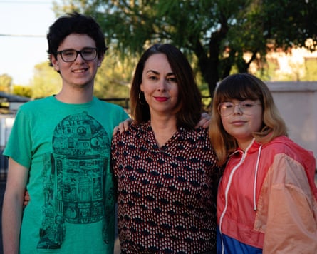Santi Ceballos, right, stands with mom Carol Brochin and brother Joaquin Ceballos outside their home in Tucson, Arizona.
