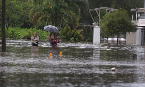 Two women wade through floodwaters in Tarpon Springs, Florida.