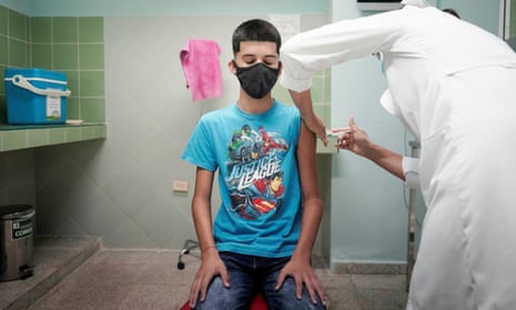 A boy gets a dose of a Covid vaccine in a clinical trial in Cuba
