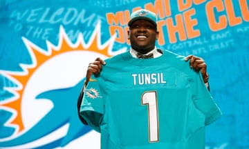 man holding a t shirt that says tunsil