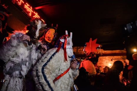 Carol performers travel from bar to bar singing to patrons on New Year’s Eve in Kyiv.