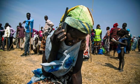 South Sudan, woman uses phone.