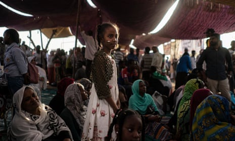 A Sudanese girl watches as protesters demand change following the ousting of Omar al-Bashir