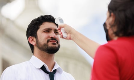 A medic checks Greg Casar’s vital signs as he leads a ‘thirst strike’ on the steps of the US Capitol in Washington DC on 25 July.