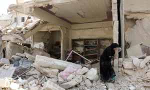 A woman inspects the damage after an airstrike in the Bab al-Nairab neighborhood of Aleppo, Syria, August 2016.