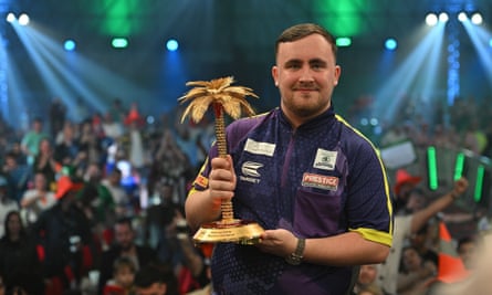 Luke Littler lifts the Bahrain Masters trophy after defeating Michael van Gerwen in the final.