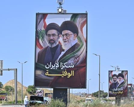 Mojtaba Khamenei and Ali Khamenei depicted on billboards