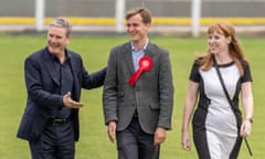 Keir Starmer and Angela Rayner smile as they stand either side of Keir Mather.