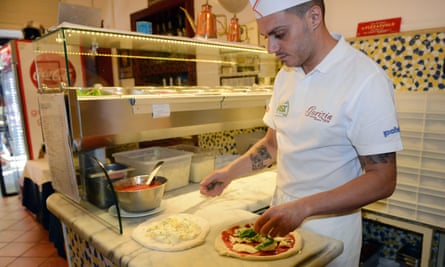 Pizzaiolo at the counter inside Pizzeria Gorizia