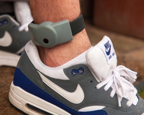 A trainer and an ankle wearing an electronic tag.
