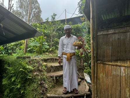 Pak standing with steps and greenery behind
