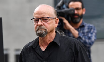 Peter Koenig outside court being filmed from behind by a camera person