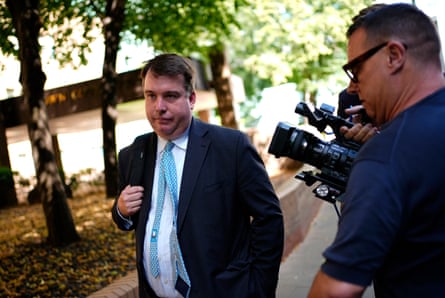 Craig Williams walks in the street outside Southwark crown court past a line of trees and press photographers.