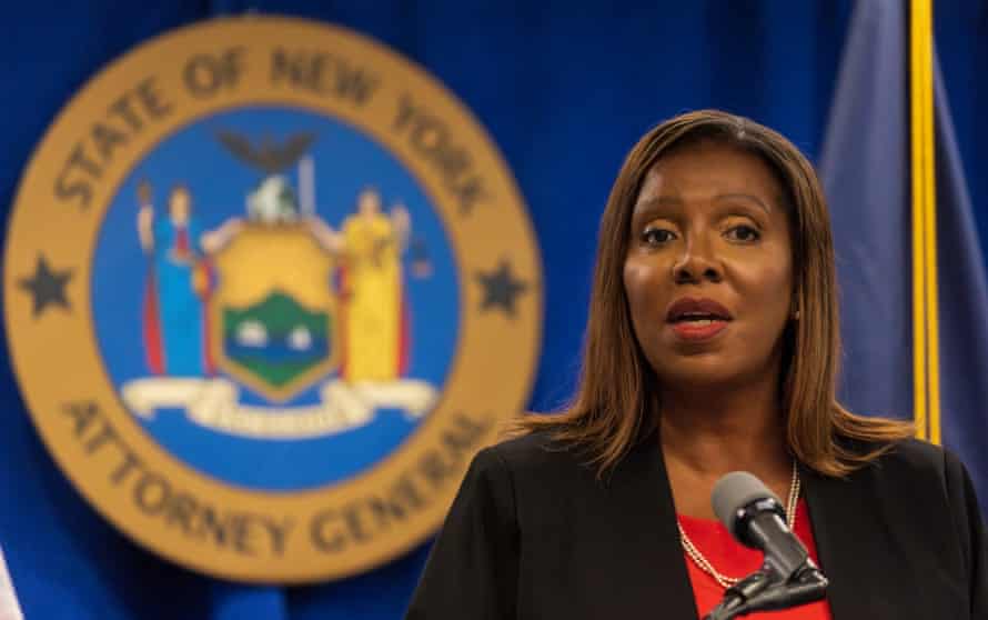 Letitia James speaks at a microphone in front of the New York attorney general seal.