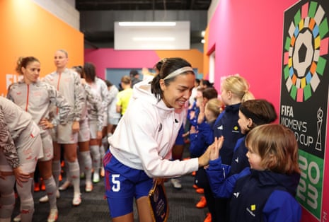 Philippines captain Hali Long high fives a mascot in the tunnel.