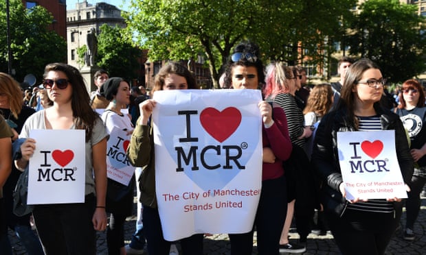 People attend a vigil for those who lost their lives during the Manchester terror attack