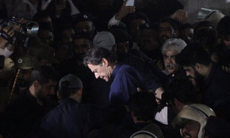Imran Khan, surrounded by his supporters, leaves the district high court in Lahore, Pakistan.