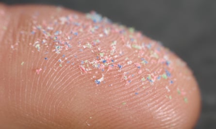 Closeup of microplastics on a fingertip