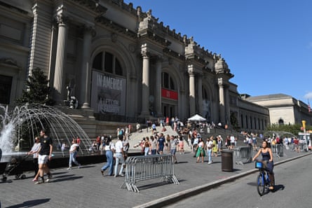 exterior image of the museum with people gathered outside and a fountain running