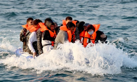Migrants crossing the Channel in a small boat on the way to Dover
