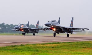Two Chinese SU-30 fighter jets take off from an unspecified location to fly a patrol over the South China Sea.