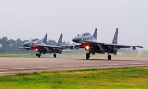 Two Chinese SU-30 fighter jets take off from an unspecified location to fly a patrol over the South China Sea. 